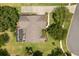 Stunning aerial view of a home with a screened pool, lush landscaping, and a long driveway at 7685 Lake Angelina Dr, Mount Dora, FL 32757