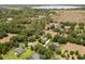 Aerial view of a home with a lake and surrounding landscape at 7685 Lake Angelina Dr, Mount Dora, FL 32757