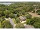 Expansive aerial view of the home nestled among mature trees and lush green landscaping at 7685 Lake Angelina Dr, Mount Dora, FL 32757