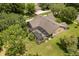 Aerial shot showcases backyard pool, mature trees, and appealing exterior of this lovely home at 7685 Lake Angelina Dr, Mount Dora, FL 32757