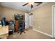 Simple bedroom with neutral walls, carpet, closet and an adjacent workspace at 7685 Lake Angelina Dr, Mount Dora, FL 32757