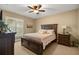 Cozy bedroom featuring a ceiling fan, plantation shutters and a warm color palette at 7685 Lake Angelina Dr, Mount Dora, FL 32757