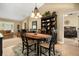 Dining area featuring a dark wood table set and views into the living room and the main bedroom at 7685 Lake Angelina Dr, Mount Dora, FL 32757