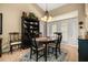 Bright dining space featuring natural light, a dark wood table, and built-in shelving at 7685 Lake Angelina Dr, Mount Dora, FL 32757