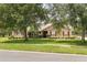 Charming single-story home with mature landscaping and red shutters at 7685 Lake Angelina Dr, Mount Dora, FL 32757