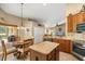 Inviting kitchen boasts granite counters, stainless appliances, and an eat-in nook with natural light at 7685 Lake Angelina Dr, Mount Dora, FL 32757