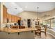 Spacious eat-in kitchen with granite counters, seating, and stainless steel appliances at 7685 Lake Angelina Dr, Mount Dora, FL 32757