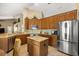 Open kitchen with granite countertops, island, stainless steel appliances and wood cabinetry at 7685 Lake Angelina Dr, Mount Dora, FL 32757