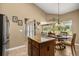 Well-lit kitchen featuring granite countertops, central island, and breakfast nook with backyard view at 7685 Lake Angelina Dr, Mount Dora, FL 32757