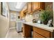 A well-organized laundry room with a front-load washer, cabinets, and a large countertop area at 7685 Lake Angelina Dr, Mount Dora, FL 32757
