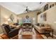 Bright living room with high ceilings, ceiling fan, hardwood floors and comfortable seating at 7685 Lake Angelina Dr, Mount Dora, FL 32757