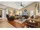 Comfortable living room featuring hardwood floors, neutral colors, and a vaulted ceiling at 7685 Lake Angelina Dr, Mount Dora, FL 32757