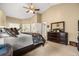 Bright main bedroom featuring a ceiling fan, neutral colors and an ensuite bathroom at 7685 Lake Angelina Dr, Mount Dora, FL 32757