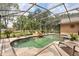 The backyard features a sparkling screened-in pool with stone patio at 7685 Lake Angelina Dr, Mount Dora, FL 32757