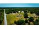 An aerial perspective shows a home nestled among trees, highlighting the expansive lot and rural setting at 7701 Groveland Farms Rd, Groveland, FL 34736