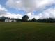 Spacious grassy property with an inviting home, perfect for homesteading or development at 7701 Groveland Farms Rd, Groveland, FL 34736