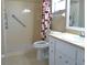 Bright bathroom with a walk-in shower featuring safety bars and vanity with modern fixtures at 8431 Sw 93Rd Pl # F, Ocala, FL 34481