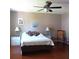 Cozy bedroom with ceiling fan, neutral walls, and warm wood flooring at 8431 Sw 93Rd Pl # F, Ocala, FL 34481