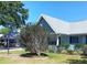 Well-maintained home showcasing a beautifully landscaped front yard and a charming covered porch at 8431 Sw 93Rd Pl # F, Ocala, FL 34481