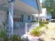 Inviting front porch with white railings and patio seating, perfect for relaxing outdoors at 8431 Sw 93Rd Pl # F, Ocala, FL 34481