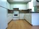 Well-lit kitchen featuring sleek, white cabinets, laminate wood flooring, and modern appliances at 8431 Sw 93Rd Pl # F, Ocala, FL 34481