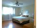 Comfortable main bedroom with a queen-sized bed, an ensuite bathroom, and a traditional wooden dresser at 8431 Sw 93Rd Pl # F, Ocala, FL 34481