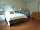 Cozy main bedroom features a queen-sized bed, an ensuite bathroom, and a traditional wooden dresser at 8431 Sw 93Rd Pl # F, Ocala, FL 34481