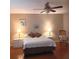 This bedroom features a ceiling fan, two side tables with lamps, and a rocking chair at 8431 Sw 93Rd Place # F, Ocala, FL 34481