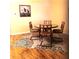 Cozy dining area with a round table, four chairs, and a decorative rug under a goose artwork at 8431 Sw 93Rd Place # F, Ocala, FL 34481
