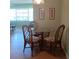 Cozy dining area with a glass top table and four wicker chairs at 8431 Sw 93Rd Place # F, Ocala, FL 34481