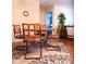 Charming dining area with rattan chairs and a patterned rug, perfect for cozy meals at 8431 Sw 93Rd Place # F, Ocala, FL 34481