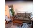 Cozy living room featuring a comfortable sofa, accent chair, and decorative rug at 8431 Sw 93Rd Place # F, Ocala, FL 34481