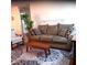 Cozy living room featuring a comfortable sofa, accent chair, and decorative rug at 8431 Sw 93Rd Place # F, Ocala, FL 34481