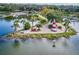 Aerial view of a lighthouse and park on the water, featuring walking paths and lush greenery at 8492 Hartford Way, Mount Dora, FL 32757