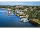 Aerial view of lakefront homes with docks and boats, surrounded by lush greenery and water views at 8492 Hartford Way, Mount Dora, FL 32757