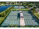Aerial view highlights tennis and pickleball courts, offering a variety of recreational activities at 8492 Hartford Way, Mount Dora, FL 32757