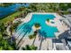 Aerial view features an expansive pool area with ample lounge space and palm trees, ideal for relaxation at 8492 Hartford Way, Mount Dora, FL 32757