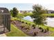 Lush backyard featuring a scenic pond view, vibrant landscaping, and a serene atmosphere at 8492 Hartford Way, Mount Dora, FL 32757