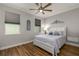Cozy bedroom with hardwood floors, natural light, and decorative accents creating a relaxing atmosphere at 8492 Hartford Way, Mount Dora, FL 32757