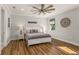 Stylish bedroom with warm wood floors, a ceiling fan, and serene decor for restful nights at 8492 Hartford Way, Mount Dora, FL 32757