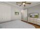 Comfortable bedroom featuring a closet, tv, and stylish dresser, all bathed in soft light at 8492 Hartford Way, Mount Dora, FL 32757