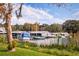 Waterfront boat dock featuring several boats docked on a lake with views of the boat storage area at 8492 Hartford Way, Mount Dora, FL 32757