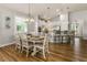 Open-concept dining area connects seamlessly to the kitchen with barstool seating at 8492 Hartford Way, Mount Dora, FL 32757