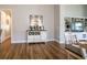 Dining area with stylish furniture and a view of the built-in shelving and kitchen at 8492 Hartford Way, Mount Dora, FL 32757