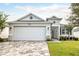 Charming single-story home with a paver driveway, two-car garage, and well-maintained landscaping at 8492 Hartford Way, Mount Dora, FL 32757