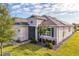 Beautiful single-story home with lush landscaping, stone accents, and a well-manicured lawn at 8492 Hartford Way, Mount Dora, FL 32757