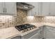 Close-up of the gourmet kitchen with marble countertops and a gas range cooktop at 8492 Hartford Way, Mount Dora, FL 32757