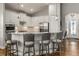 Open kitchen with island seating, sleek appliances, and stylish pendant lighting at 8492 Hartford Way, Mount Dora, FL 32757