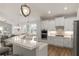 Modern kitchen with white cabinets, stainless steel appliances, and granite countertops at 8492 Hartford Way, Mount Dora, FL 32757