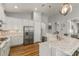 Bright kitchen with white cabinets, stainless appliances, and a central island at 8492 Hartford Way, Mount Dora, FL 32757